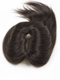A dark brown hairpiece or wig topper with a central part, photographed from above on a plain white background.